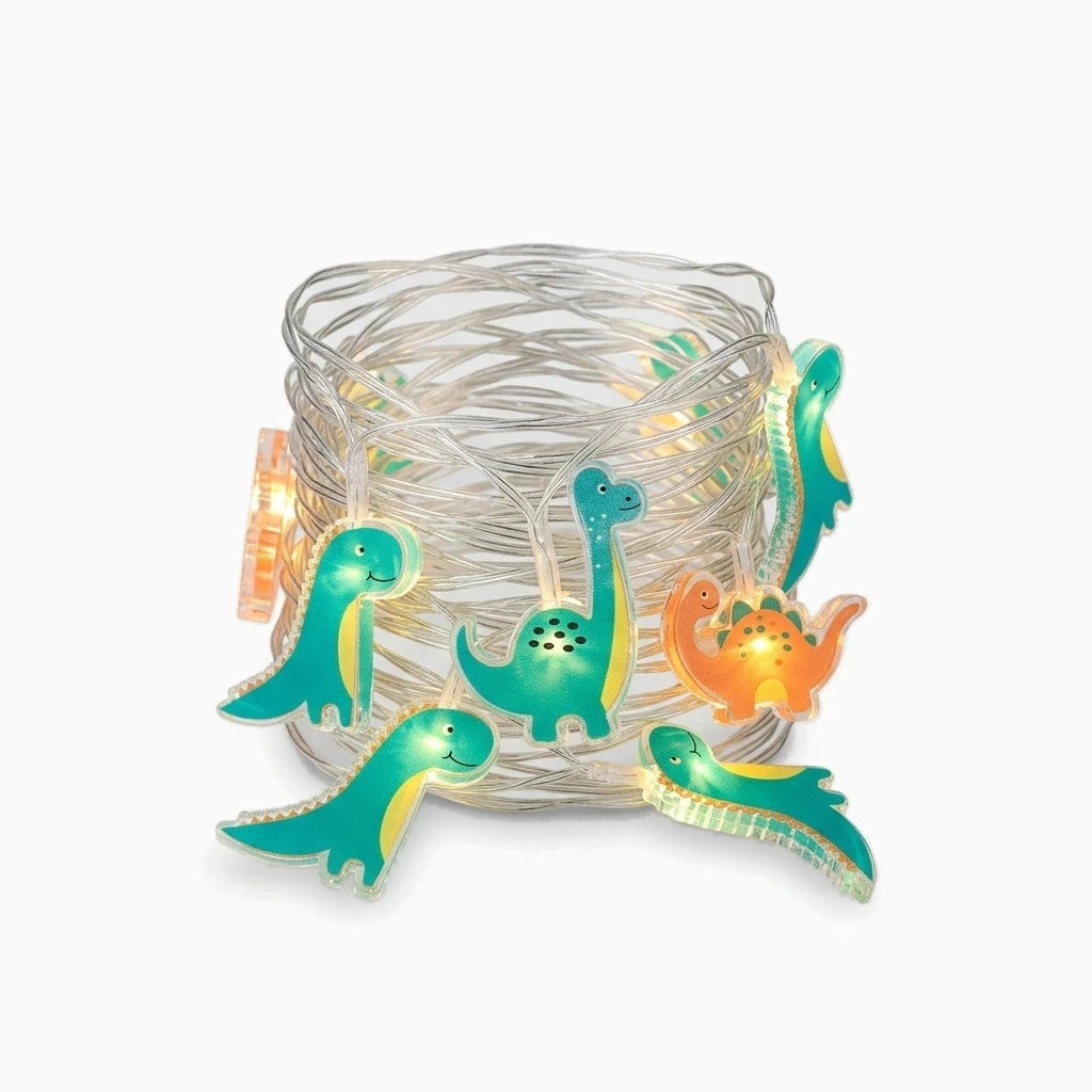 Petits dinosaures lumineux blancs suspendus au-dessus d'un lit d'enfant