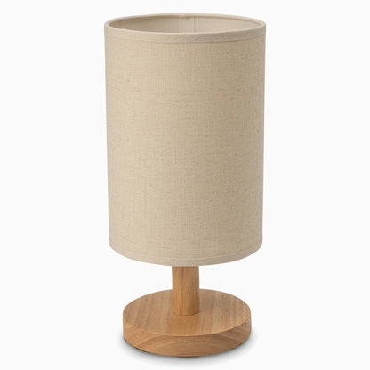 Lampe à poser bois avec abat-jour cylindrique et pied en bois clair sur table de nuit