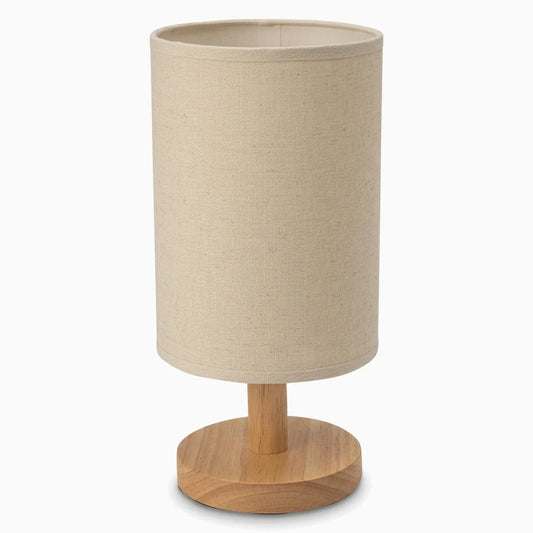 Lampe à poser bois avec abat-jour cylindrique et pied en bois clair sur table de nuit