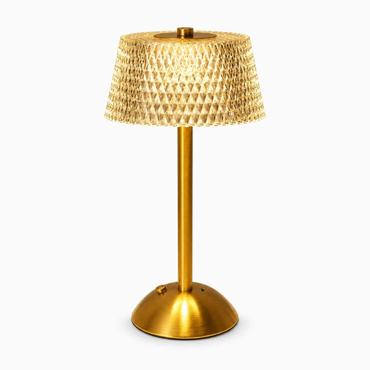 Lampe cocooning tactile en verre dépoli diffusant une lumière chaude sur une table de chevet