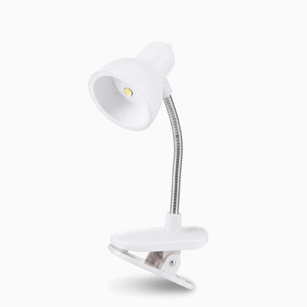 Clip lumineux rechargeable en rose pâle attaché à un livre ouvert, idéal pour la lecture en soirée